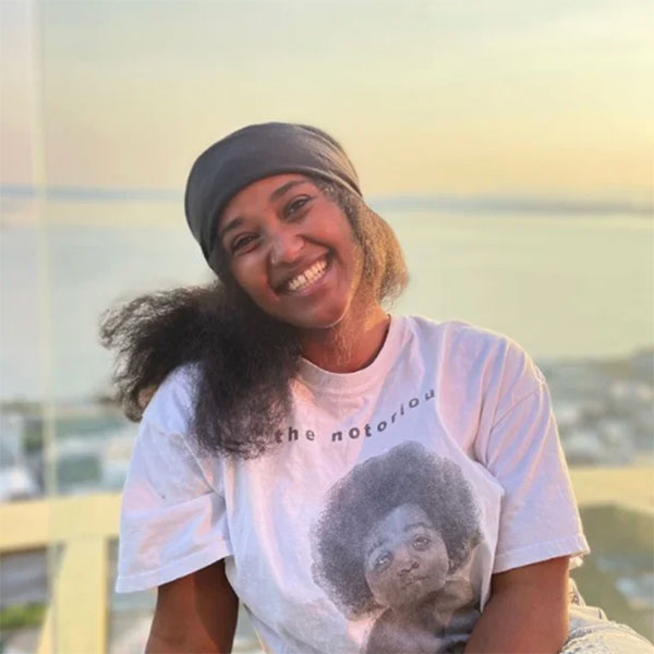 Smiling selfie with skyline behind Fifi Kelile